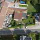 HOUTAIN : Ensemble immobilier: Maison 4ch avec jardin, surface commerciale, 3 appartements, terrain.